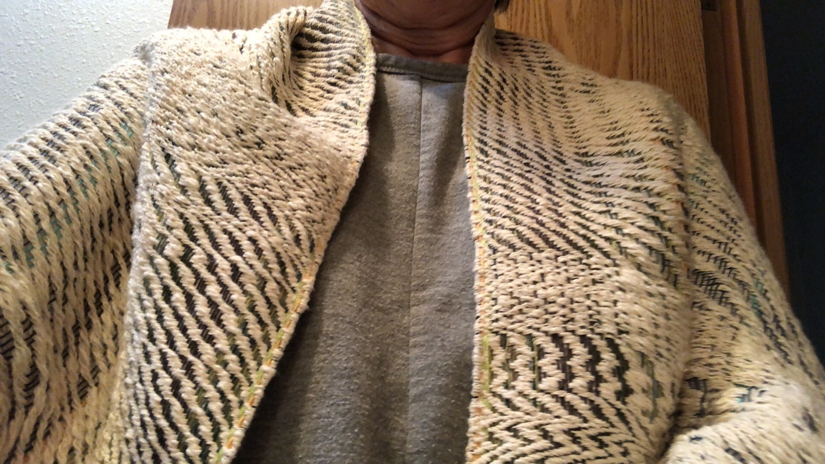 A woman in a handwoven knitted shawl